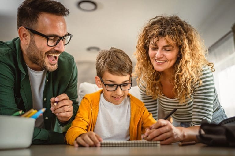 Family writing their family history stories together to preserve faith and honor their ancestors.