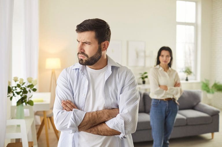 Husband and wife in conflict illustrating a struggling relationship and the need for emotional safety and marriage counseling.