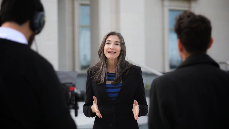 A media representative speaks outside the Bahía Blanca Argentina Temple during media day, inviting the community to attend the temple open house and feel peace.