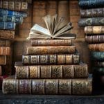Stack of antique books symbolizing personal life stories, faith and growth, and discovering God’s hand in our lives.