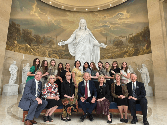 Elder LeGrand R. Curtis Jr. and volunteers from the Wilford Woodruff Papers Project gathered at the Rome Italy Temple Visitors’ Center, symbolizing intergenerational service.