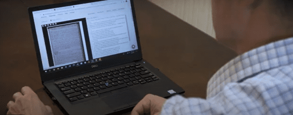 Volunteer reviewing a digitized Wilford Woodruff document on a laptop as part of the Wilford Woodruff Papers Project volunteer service.