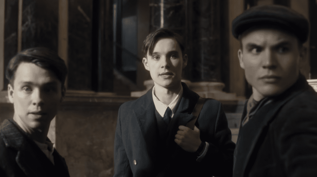 Scene from Truth or Treason Angel Studios movie showing Helmuth Hubener with his friends Rupert Evans and Karl-Heinz Schnibbe as they risk their lives to spread truth.