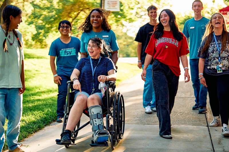 Latter-day Saint youth smiling and walking together during a For the Strength of Youth (FSY) conference in 2026, building faith and friendships