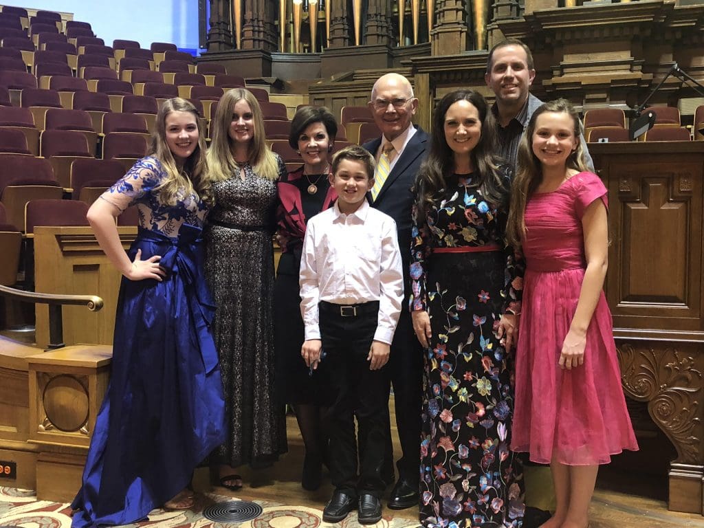 President Dallin H. Oaks surrounded by his children and grandchildren at a family event, representing his role as both prophet and loving father.