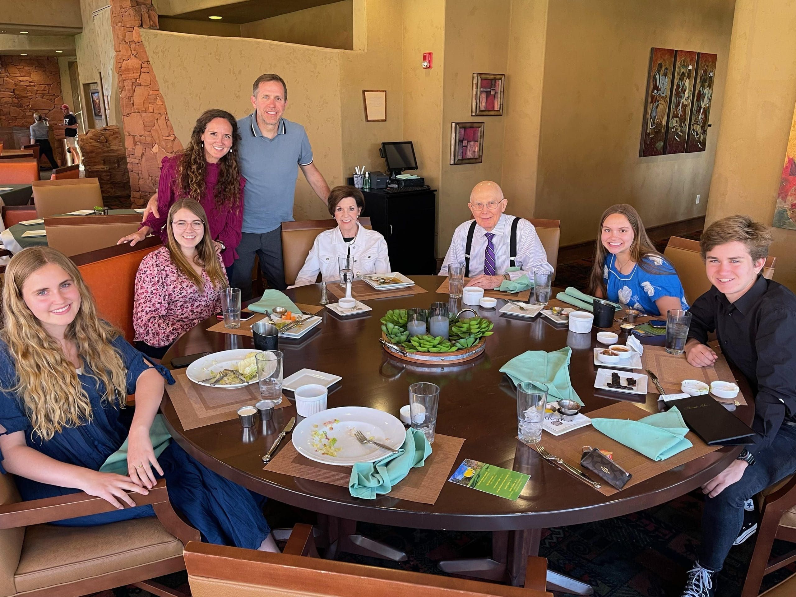  President Dallin H. Oaks seated at dinner with family, teaching principles of work, faith, and testimony around the table as described in the article.