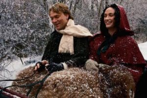 Joseph and Emma Smith riding a horse-drawn sleigh in winter, illustrating themes connected to early Latter-day Saint history and Section 132 authorship discussions.
