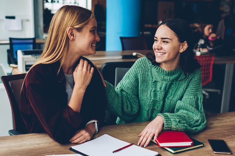 Two friends talking with warmth and support, illustrating staying connected when friends leave the Church despite faith differences.