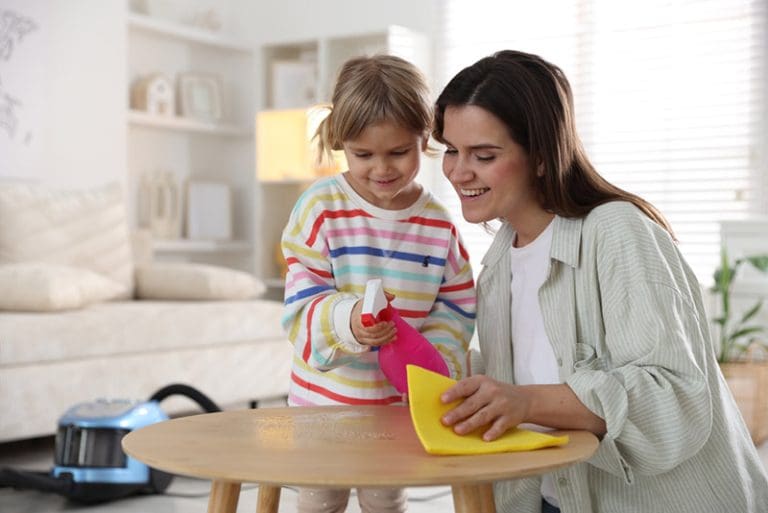 Mother and child cleaning together at home, symbolizing God’s mercy and messy discipleship through the gospel of Jesus Christ.