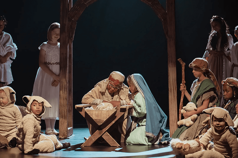 Children reenact the Nativity scene as part of the 2025 Light the World invitation to celebrate the birth of Jesus Christ through meaningful Christmas traditions. The children—dressed as Mary, Joseph, shepherds, angels, and sheep—gather reverently around the manger, reflecting the campaign’s focus on acts of kindness, Christ-centered worship, and sharing the Christ Child video.