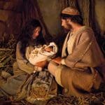 Mary and Joseph holding the newborn Christ Child in a stable, inviting us to feel closer to Christ this Christmas.