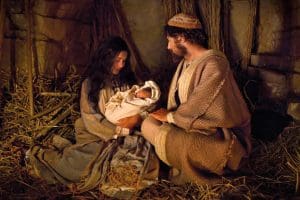 Mary and Joseph holding the newborn Christ Child in a stable, inviting us to feel closer to Christ this Christmas.