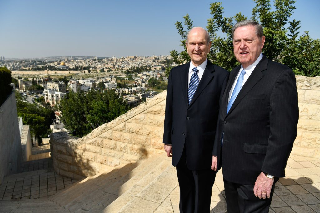 President Jeffrey R. Holland stands overlooking Jerusalem with President Russell M Nelson, reflecting his testimony of Jesus Christ and his role in strengthening faith worldwide.