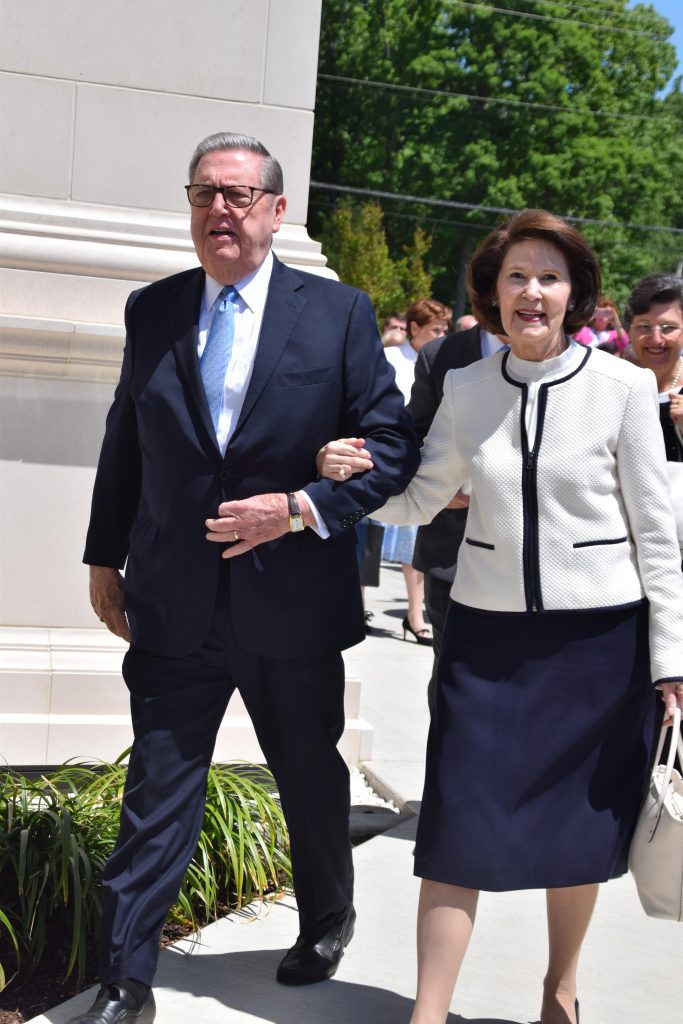 President Jeffrey R. Holland walks arm in arm with his wife, Patricia Holland, symbolizing their lifelong partnership, faith, and devotion to Jesus Christ.