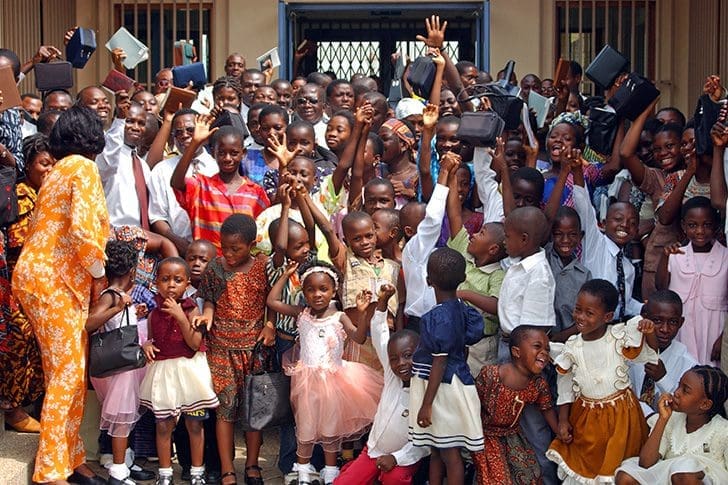 West African Latter-day Saint members celebrating together, symbolizing the global blessings of Official Declaration 2 and the continuing revelation taught in the Articles of Faith.