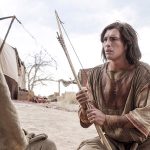 Nephi holding a bow in the wilderness, symbolizing Nephi’s divine authority and his God-appointed leadership in the Book of Mormon.