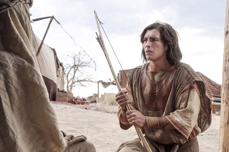 Nephi holding a bow in the wilderness, symbolizing Nephi’s divine authority and his God-appointed leadership in the Book of Mormon.