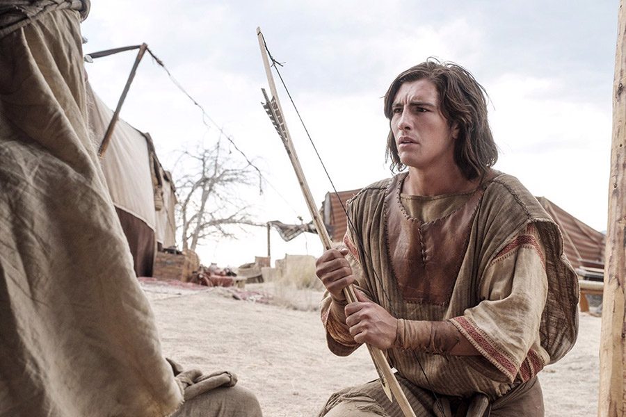 Nephi holding a bow in the wilderness, symbolizing Nephi’s divine authority and his God-appointed leadership in the Book of Mormon.