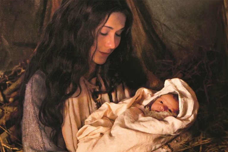 Mary holding the infant Jesus Christ, the Light of the World, whose birth fulfilled Messianic prophecy and brought hope during the Christmas season.