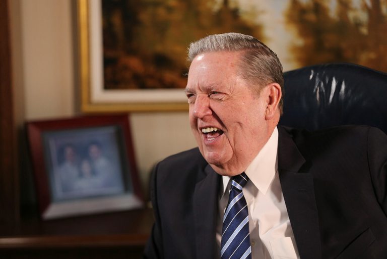 President Jeffrey R. Holland smiling during an interview, remembered for his faith in Jesus Christ and powerful apostolic ministry