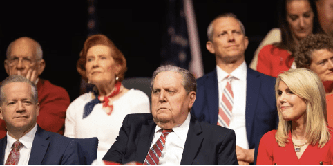 President Jeffrey R. Holland seated among Church leaders during general conference, listening with solemn reflection.