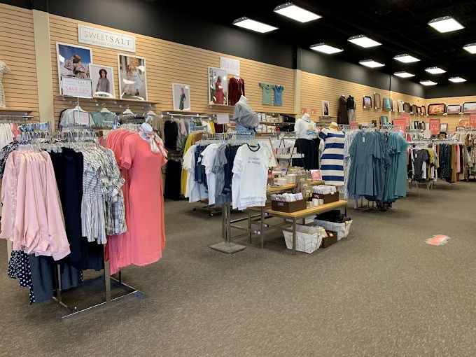 An interior view of a Seagull Book store shortly before its announced closure, showcasing Sweet Salt clothing displays, modest apparel options, and LDS retail products during the final season before the Seagull Book closure.