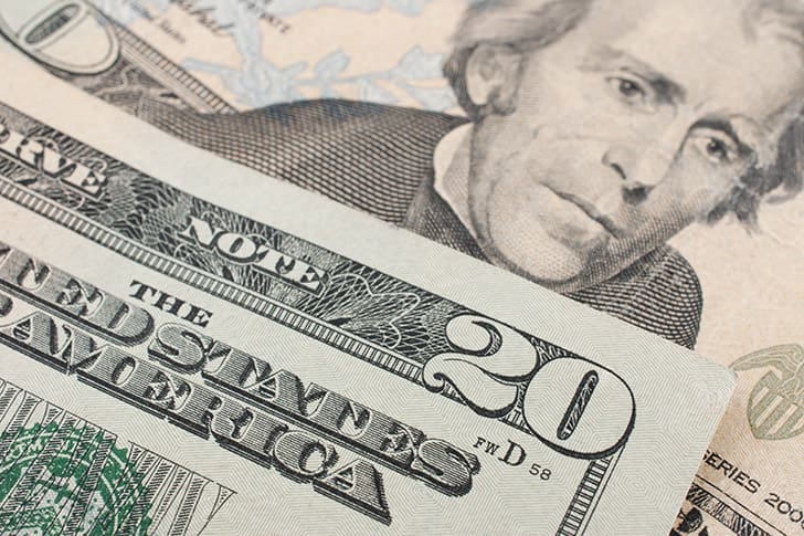 A detailed view of U.S. currency symbolizing the voluntary subscription support that keeps Meridian Magazine publishing daily inspiration, spiritual resources, and faith-affirming content for Latter-day Saints.