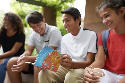 Children reading gospel materials together as they prepare to join the youth program of The Church of Jesus Christ of Latter-day Saints