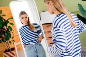 Woman struggling with body image and comparison, reflecting the need for a gospel view of body image through Jesus Christ and restored truth