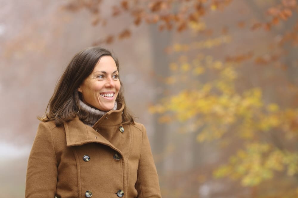 Single Latter-day Saint woman walking thoughtfully outdoors, representing discipleship and covenant faith during a season of singleness.