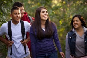 Young adults walking together outdoors, illustrating Divine Observation and dating with a heart at peace rather than judgment or fear.