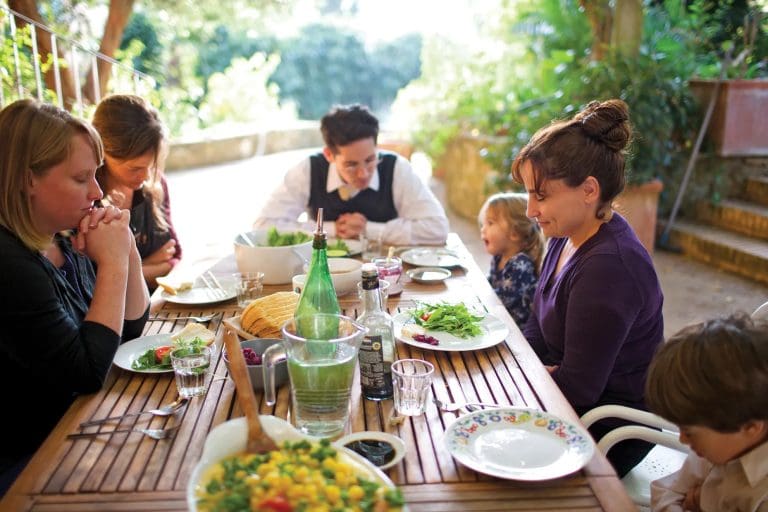 Family sharing a meal together, reflecting how small acts of charity and kindness—like Biscuits and Gravy—can strengthen marriage and relationships