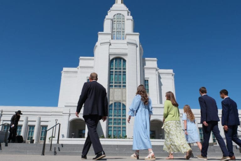 A family approaching an LDS temple, representing faithful temple attendance and trusting the Spirit even during quiet spiritual experiences.