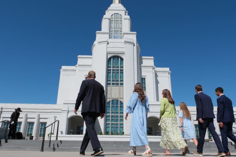 A family approaching an LDS temple, representing faithful temple attendance and trusting the Spirit even during quiet spiritual experiences.