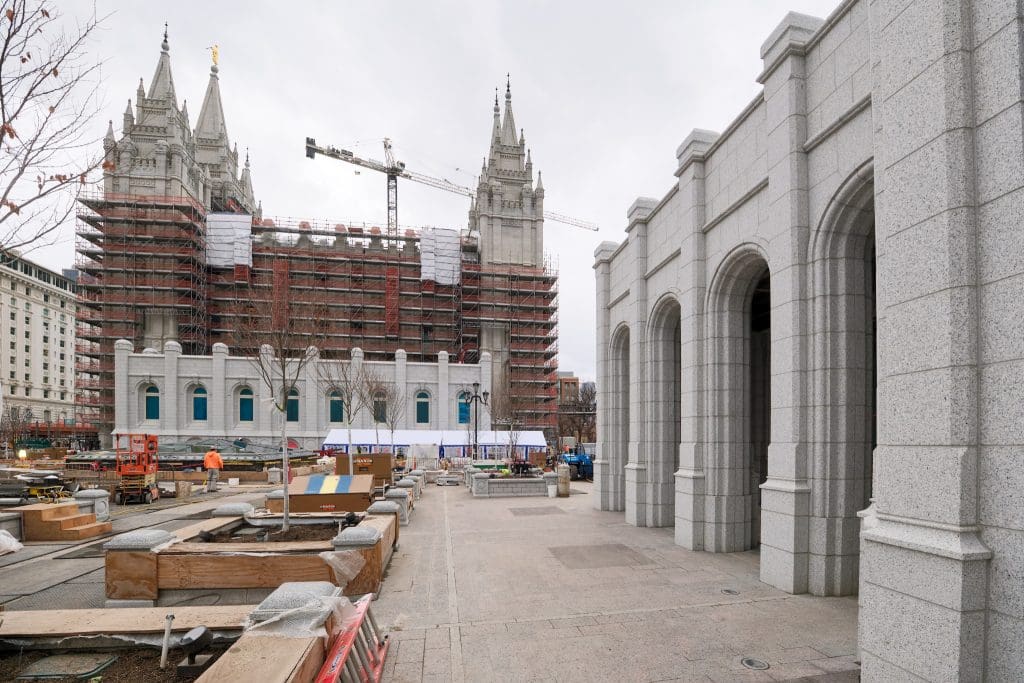 Exterior scaffolding remains on portions of the Salt Lake Temple as renovation work progresses, revealing cleaned stone walls and restored architectural details at Temple Square.