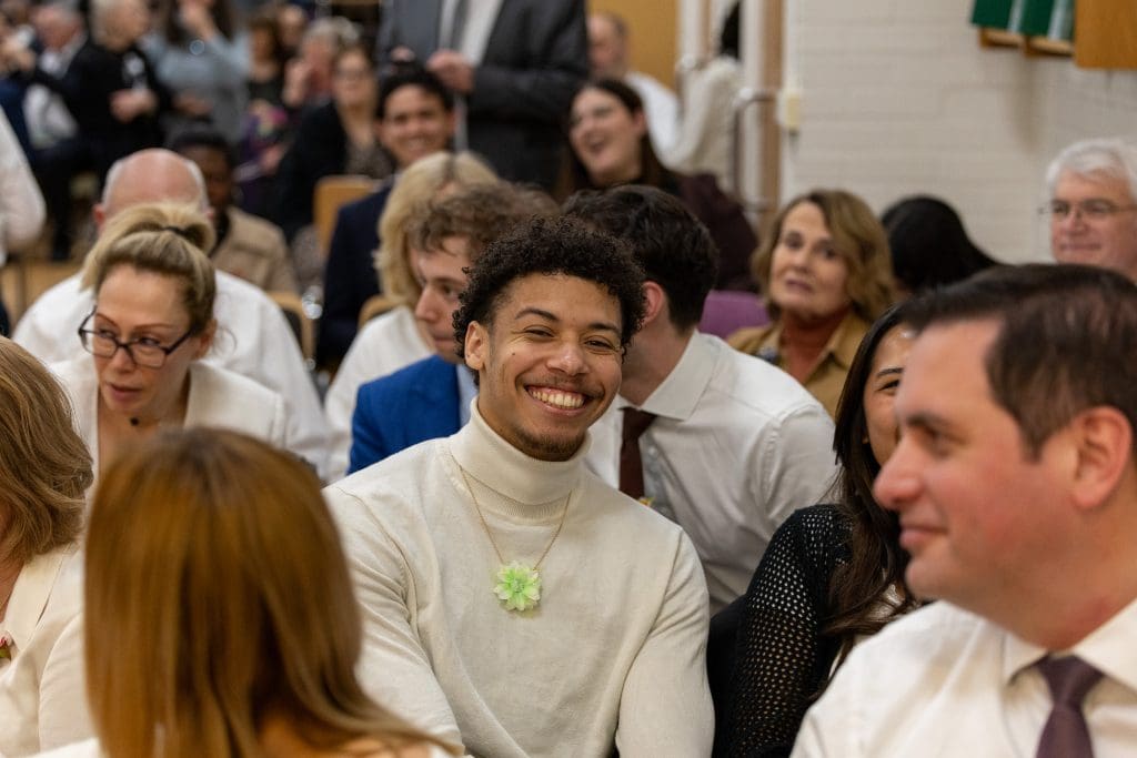 Latter-day Saints and friends gather in Paris during a devotional with Elder Gérald Caussé, reflecting excitement over Church growth in France and new baptisms.