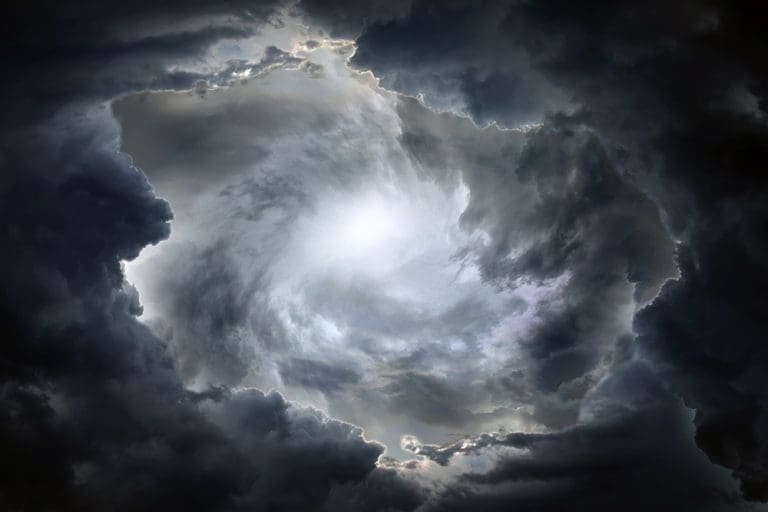 Storm clouds parting with light above, representing Noah’s Flood, divine warning, and faith amid wickedness in Genesis 6–11 and Moses 8.