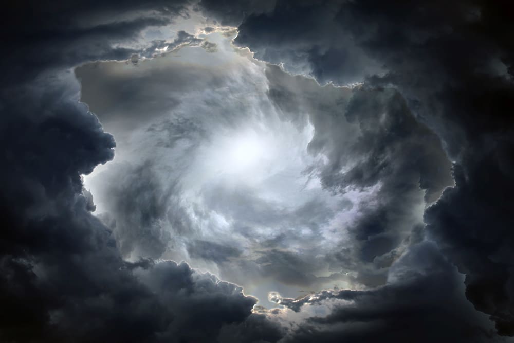 Storm clouds parting with light above, representing Noah’s Flood, divine warning, and faith amid wickedness in Genesis 6–11 and Moses 8.