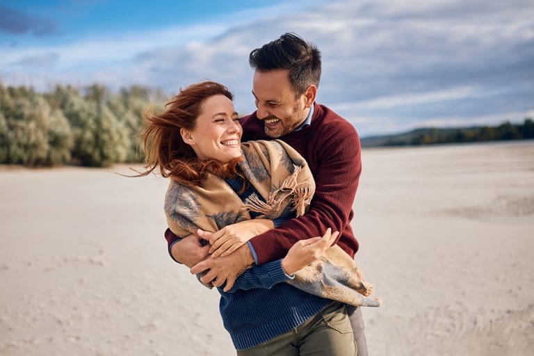 Couple embracing joyfully, representing covenant love and preparation for eternal marriage beyond dating chemistry