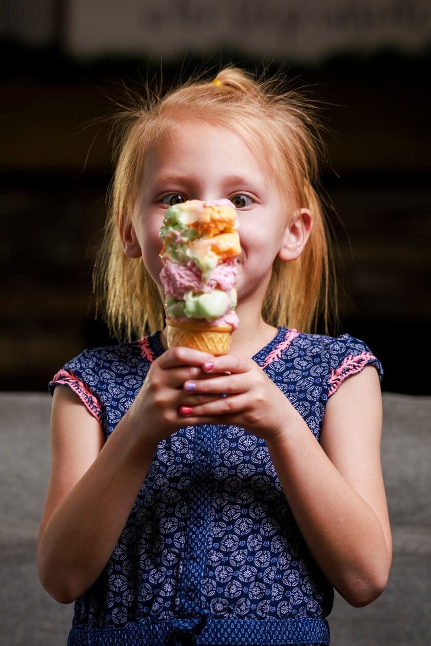 A young girl holds a tall, colorful ice cream cone, symbolizing the idea of a “Favorite” child in a family. The image reflects BYU research on parental favoritism, birth order, sibling rivalry, and how family dynamics influence children’s mental health and well-being.