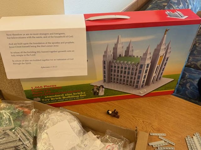 A Salt Lake Temple building set box displayed in a Church foyer, part of a creative Ward Family effort to unite members around Temple worship and temple work.