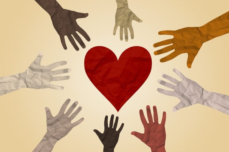 Diverse hands surrounding a heart