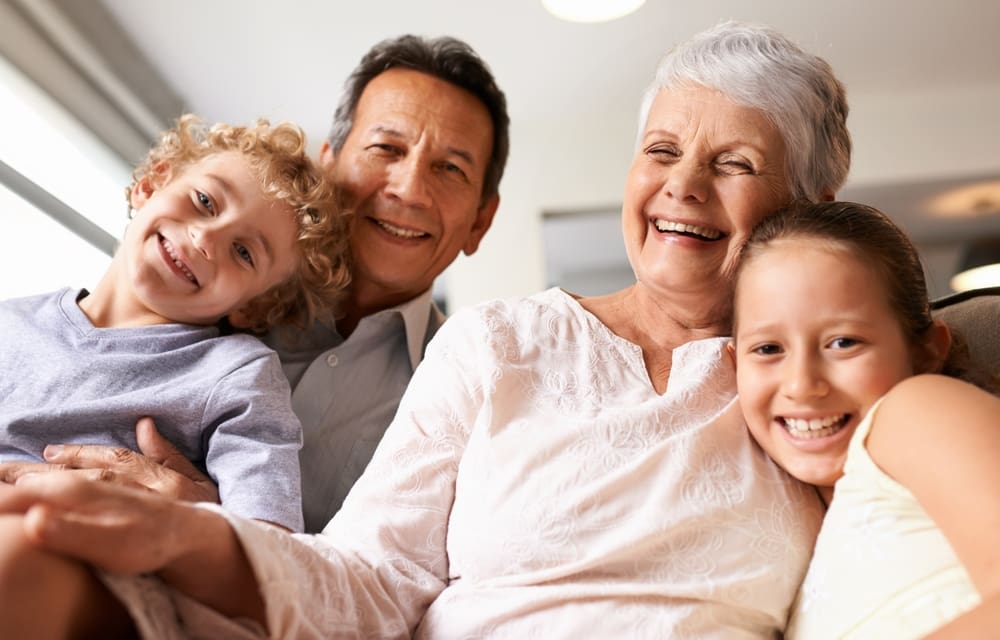 Grandparent smiling with grandchildren, representing proactive grandparenting and strong family relationships in The Grandparenting Blueprint.