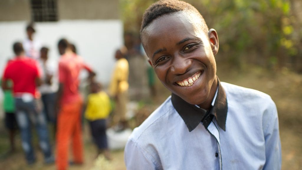 A young adult smiles confidently, representing the joy and spiritual growth fostered through participation in Institute classes.