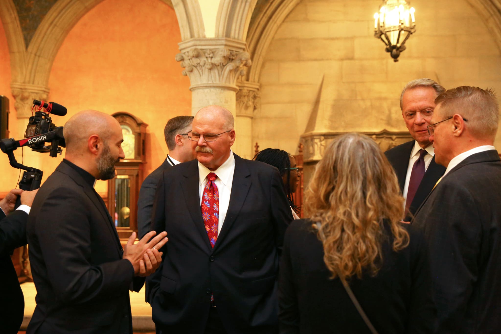 Andy Reid meets with Church leaders in a historic setting, emphasizing faith, leadership, and his role in the Tabernacle Choir at Temple Square event.