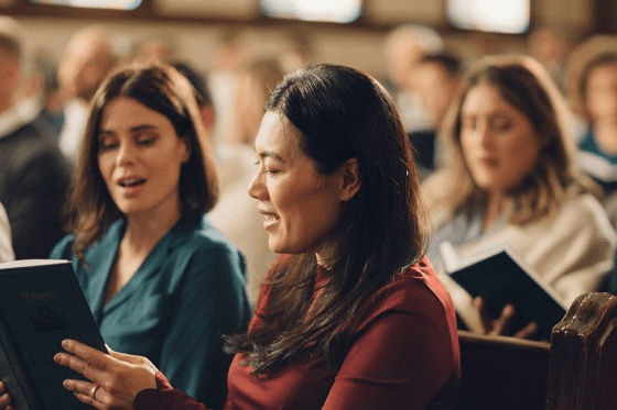 Latter-day Saints singing in sacrament meeting during Sunday School schedule change and Come Follow Me gospel learning