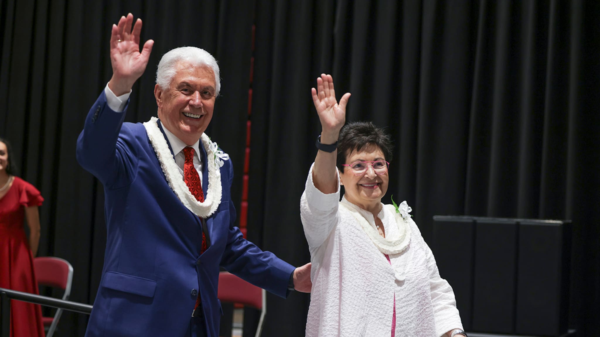 President Dieter F. Uchtdorf and Sister Harriet Uchtdorf greet the audience at BYU–Hawaii before the devotional where he spoke about unity, service, and standing together as disciples of Jesus Christ.