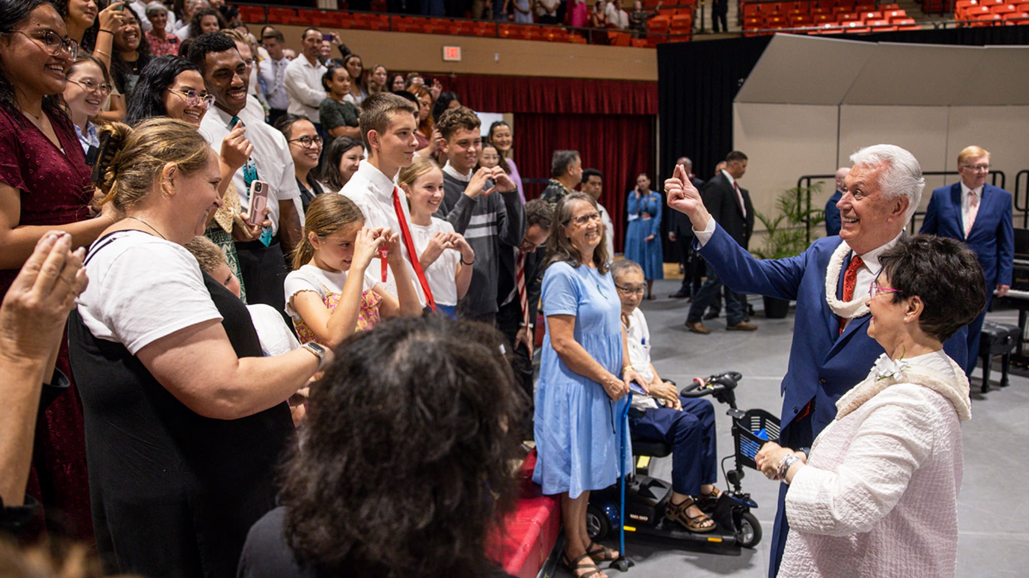 President Dieter F. Uchtdorf and Sister Harriet Uchtdorf greet students and families after the BYU–Hawaii devotional where he encouraged disciples to stand close together and lift where they stand.