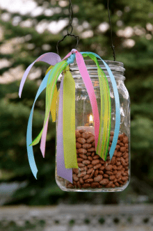A lantern decorated with colorful ribbons and filled with beans, symbolizing an Easter Vigil lantern used in family Holy Week traditions celebrating the light of Christ and the hope of Easter.