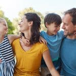 Parents showing compassion in parenting as they laugh and connect with their children, illustrating compassionate parenting and understanding children’s development.